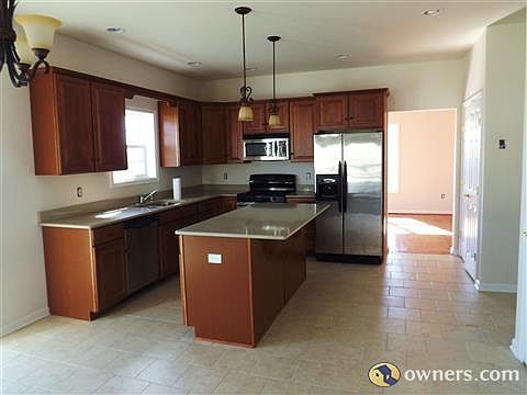 Kitchen w tile floor and stainless appliances