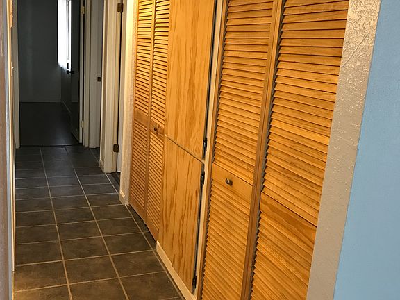 Hallway to the bedrooms
with coat closet and storage