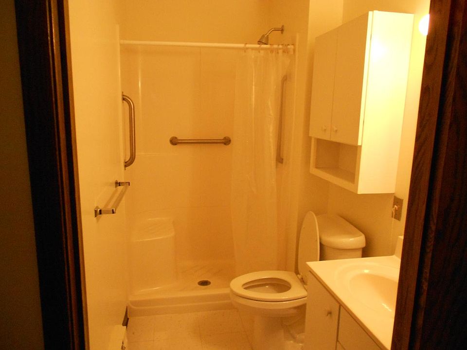 unit bathroom - white walls and white shower/sink/stool