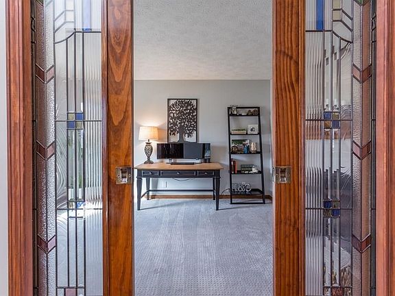 Custom pocket doors lead to large office/den.