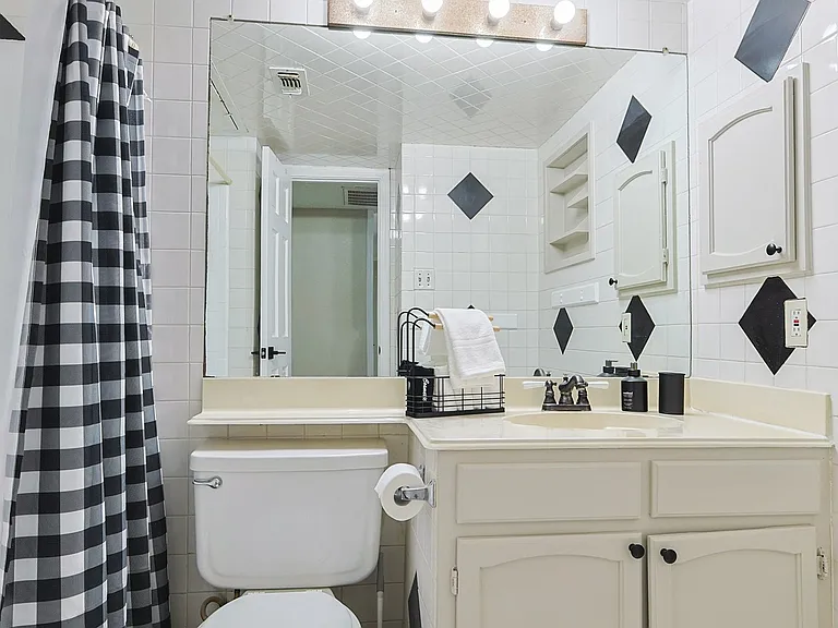 Full Bathroom 2 - shower-tub combo and bathroom essentials.