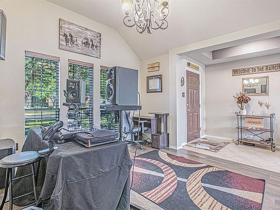 This spacious dining room has large picture windows with faux wood blinds and an oil rubbed bronze chandelier!