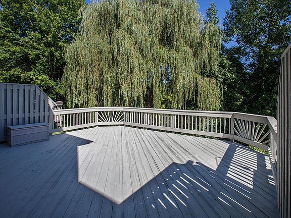 deck overlooking yard with weeping willow tree