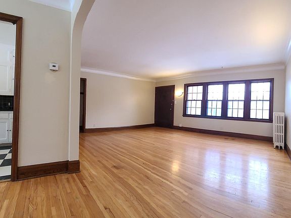 From dining room archway, view to kitchen and living room. Lots of light! Living room windows face north to street.