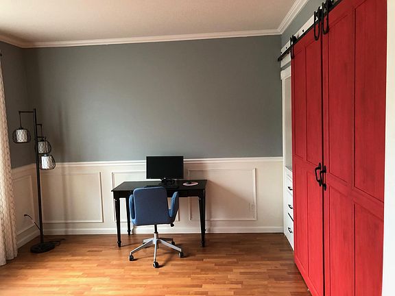 Downstairs office, guest room, or 4th bedroom with french doors to entryway. Barn doors to closet built to hold queen size bed. Built in shelving on sides of closet.