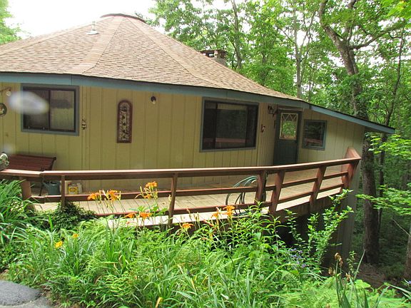 TO ENCLOSED STAIRWAY ADDITION : A DECK SURROUNDS THE HOUSE