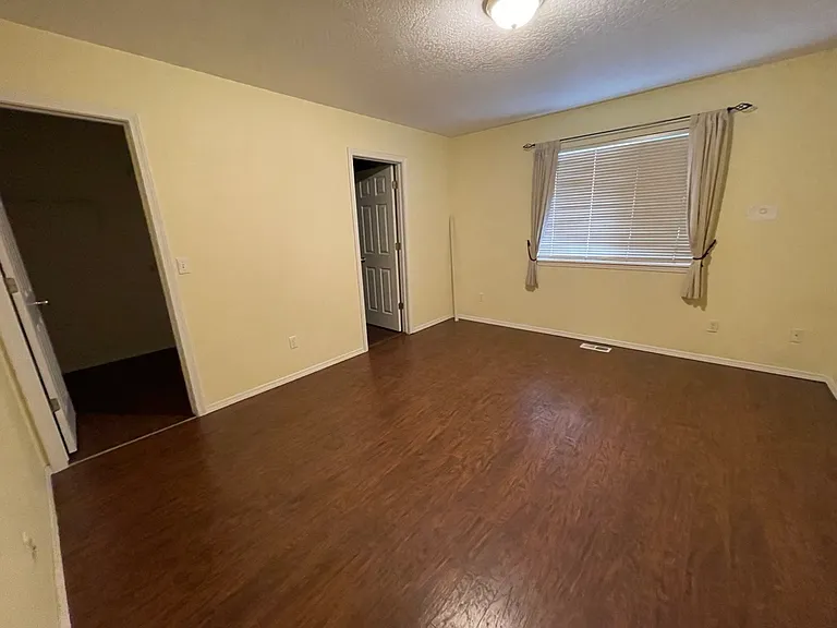 Main bedroom. Walk-in closet door is open on left, ensuite bathroom door on the right.