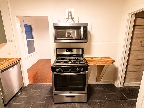 new stove and vented microwave with side countertop