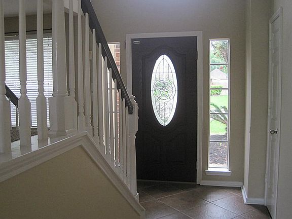 Interior view of entry, with hall closets for extra storage.