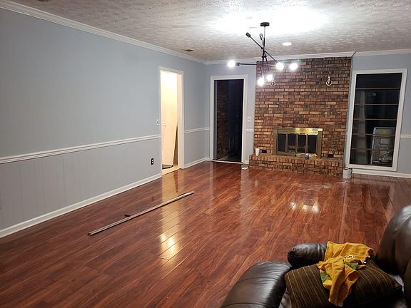 Living room with hardwood floor and fireplace.