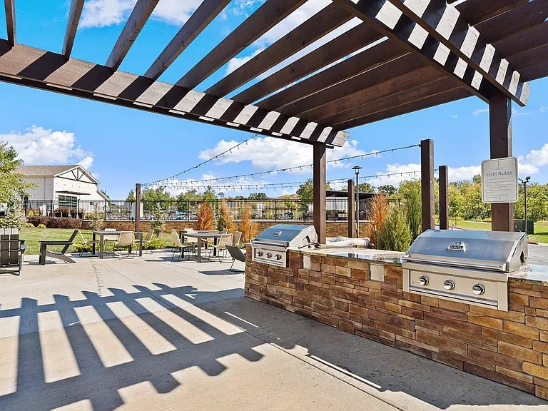 Outdoor gas grills are available to residents next to the outdoor lounge under the pergola.