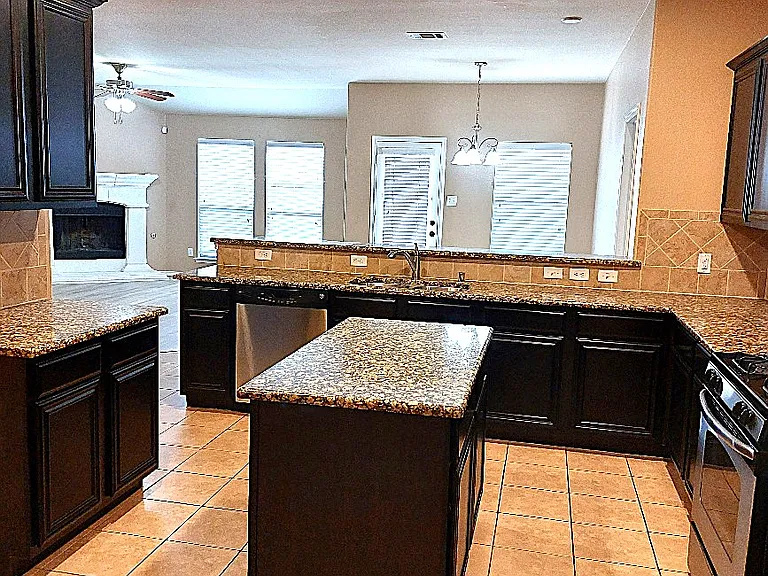 Beautiful kitchen with nice open layout, granite countertops, island, stainless appliances & abundant cabinets.