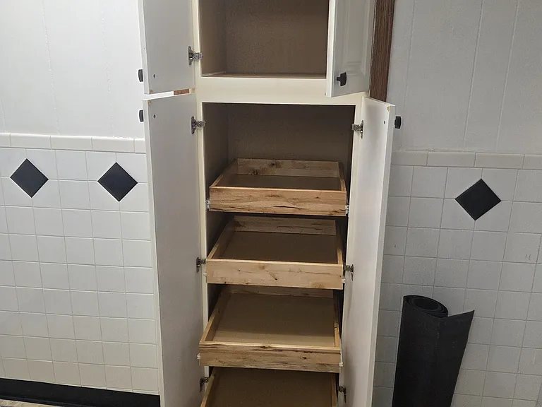 Kitchen pantry/storage cabinet with pull-out shelving for additional organization and storage space.