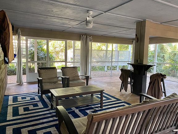 Screened in downstairs entertainment area.