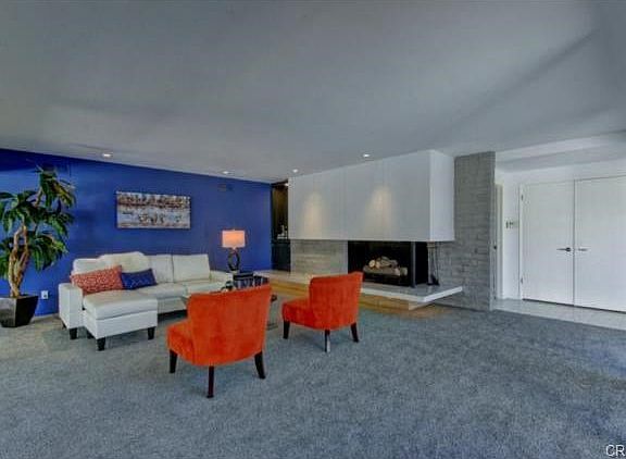 Giant living room has entire fireplace wall with cantilevered he