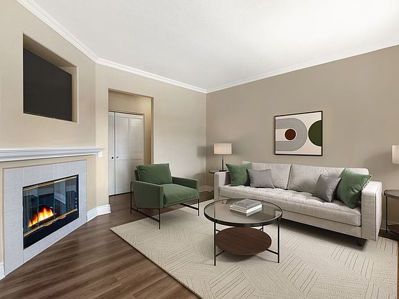 Updated Finishes living room with fireplace and upgraded hard surface flooring