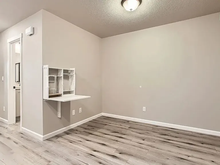 Dining/living area. Folding wall table offers a versatile eating/working area. Table can be folded up for extra space. 

(Furnished pictures coming soon).