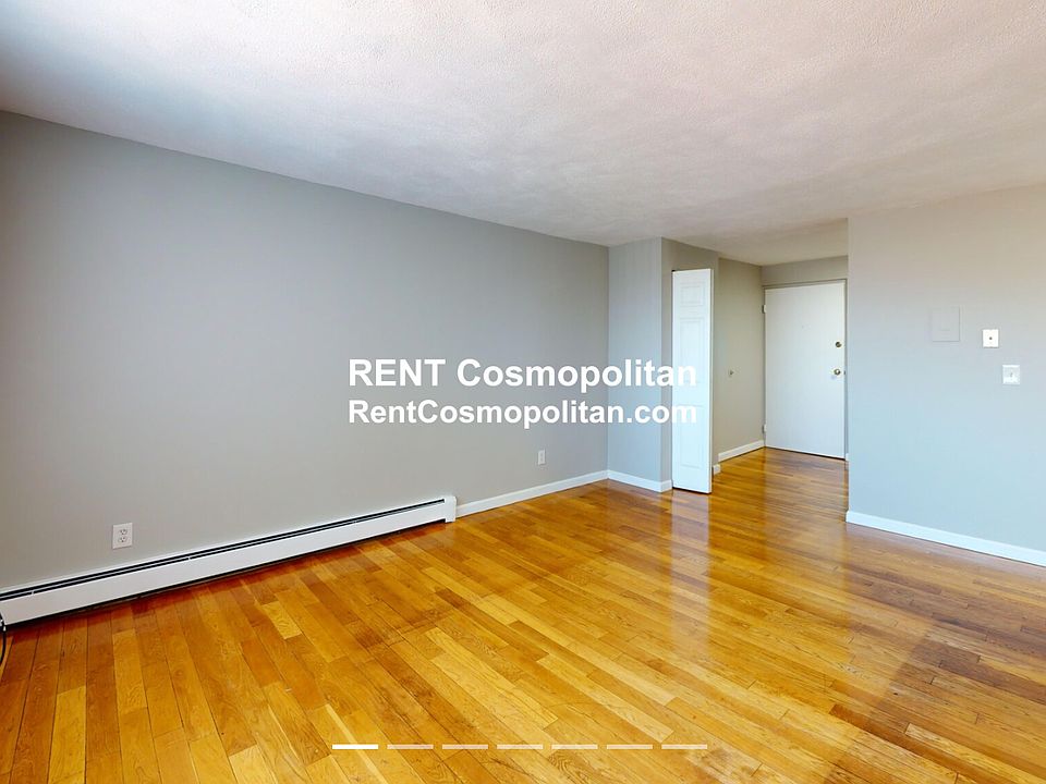 Sunny spacious living room with wall AC to cool the unit.