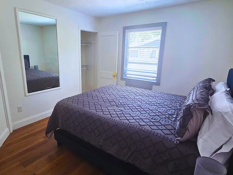 Relax in a bright, cozy bedroom with premium linens and a plush queen bed.
