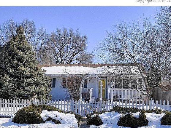 Arbor gate and white picket fence