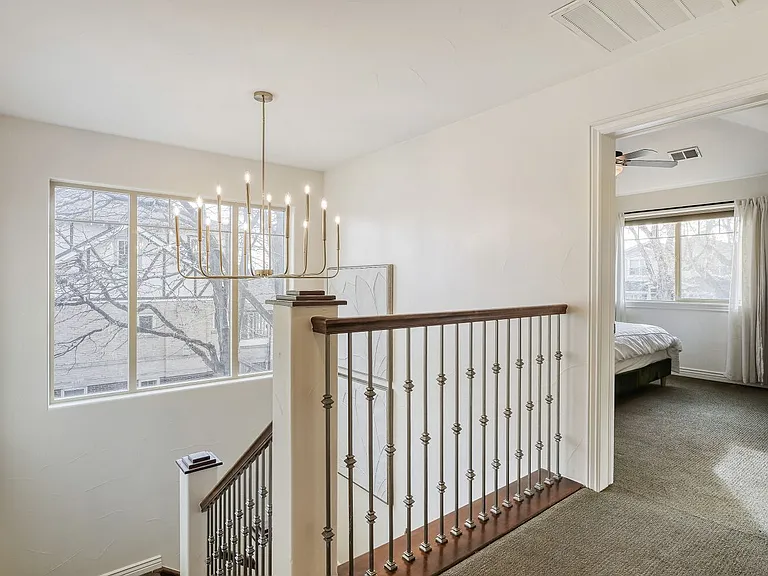 MAIN TO 1ST LEVEL STAIR WITH CHANDELIER
