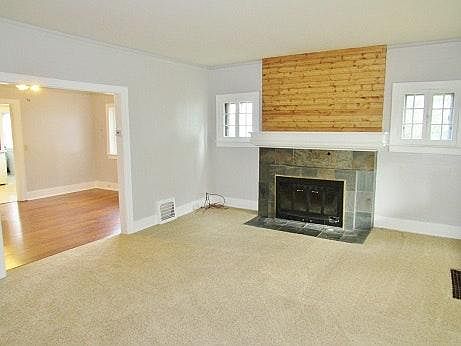 The living room has a dining room and an office/study that a