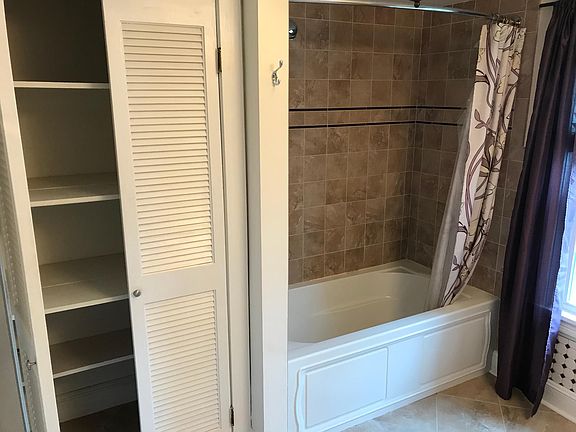 Deep tub, with shower wand, linen closet in bathroom is huge
