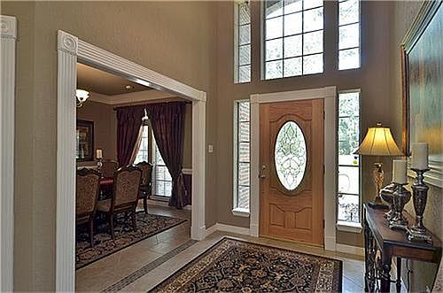 Wide entry way with tile and beveled glass front door.