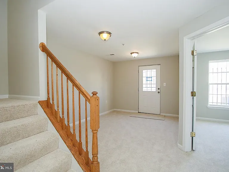 Entrance from bottom level, stairs, and bottom floor bedroom entrance. These floor has new hardwood floors installed.