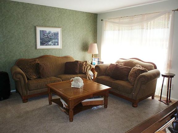 Very Cozy living room with a large window in the front.