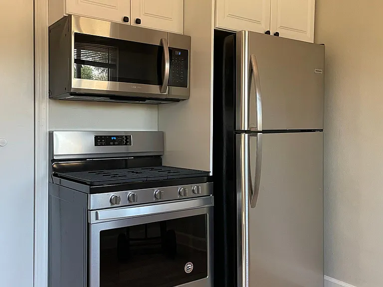 New stainless steel appliances in charming eat-in kitchen