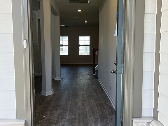 foyer entrance w laminate flooring on the entire 1st floor. coat closet to the left, powder room t