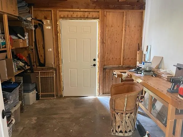 workshop / storage room with door leading out to backyard