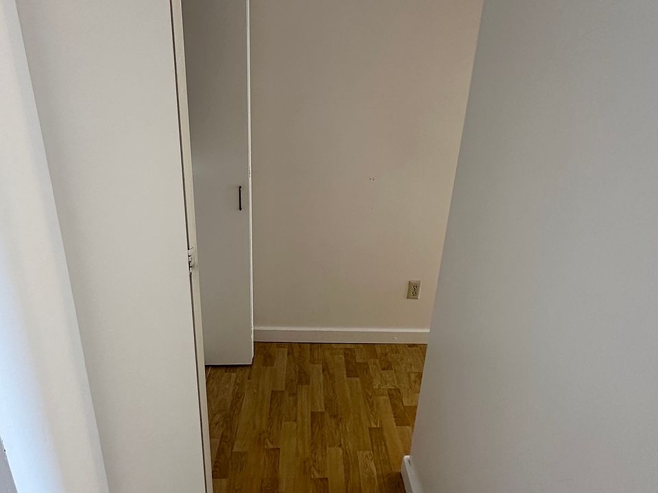 Hallway towards bathroom, washer/dryer, and bedroom