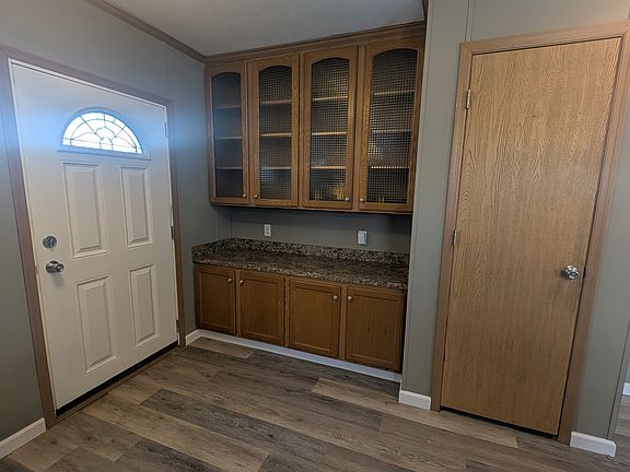 Extra Cabinets behind front entrance and coat closet or pantry