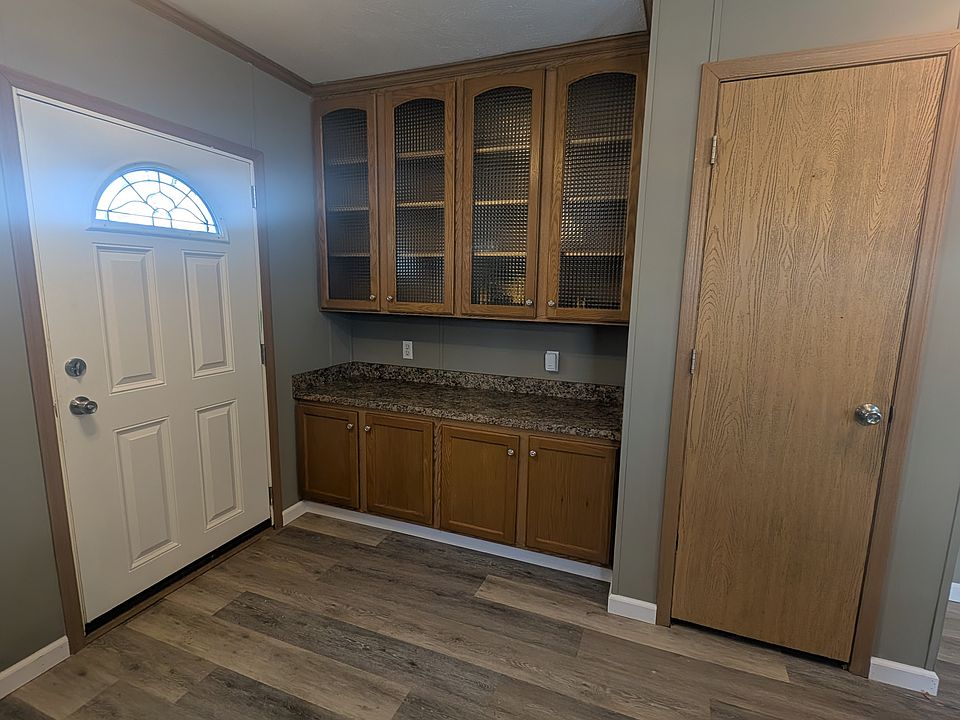 Extra Cabinets behind front entrance and coat closet or pantry