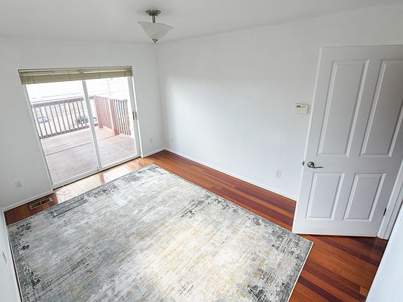 Pictured: Main level bedroom (10'x13') with private deck access

Also on this floor: 
Kitchen
Dining/Living (18'x13')
1 Bathroom
Garage access
Deck access
Stairs to top/bottom floors