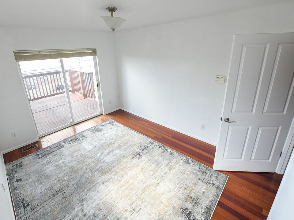 Pictured: Main level bedroom (10'x13') with private deck access

Also on this floor: 
Kitchen
Dining/Living (18'x13')
1 Bathroom
Garage access
Deck access
Stairs to top/bottom floors