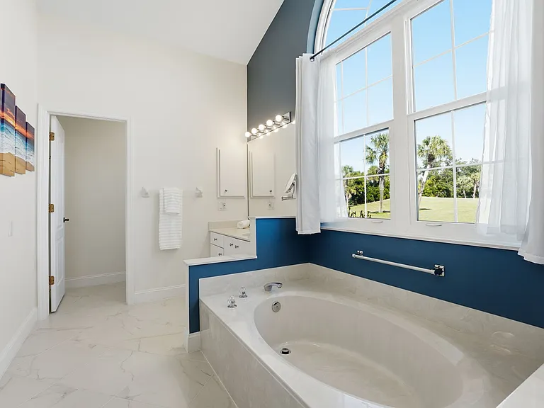 Primary bathroom with tile floors & separate water closet