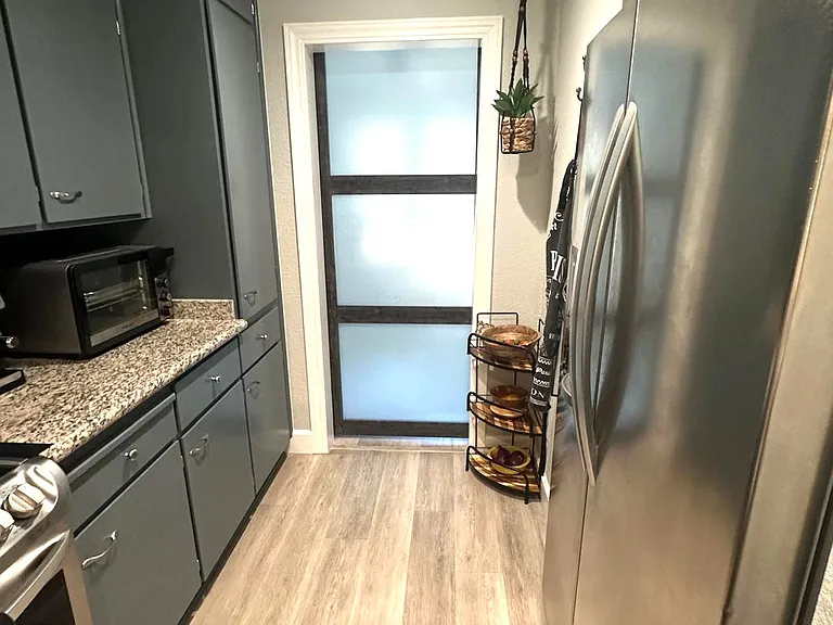 kitchen looking into office with barn door closed