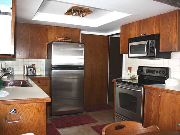 The kitchen features quality cabinetry, stainless appliances, and ceramic tile flooring.