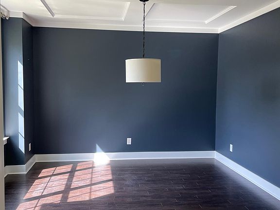 Bright dining room with decorative ceiling can also serve as an office.