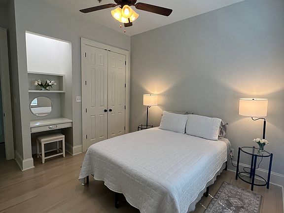bedroom with built in vanity and spacious closet.