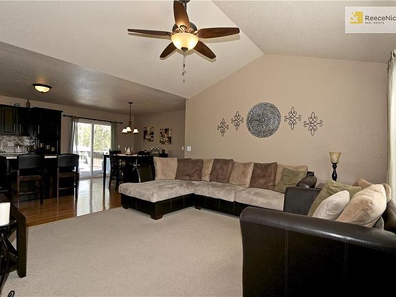 Large great room with vaulted ceilings and ceiling fan