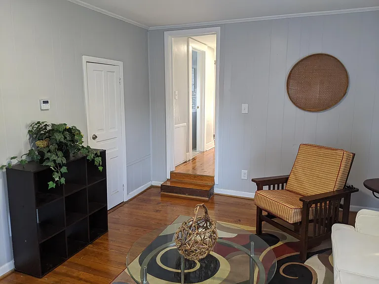 Hall leads from living room to rest of unit.