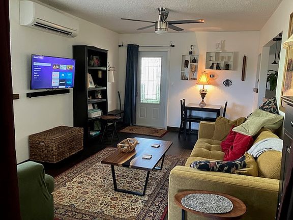 Furnished living room overlooking main entrance at far end.