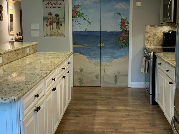 Kitchen towards laundry room and hand painted pocket doors