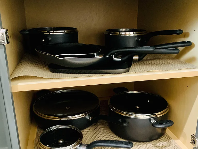 Cookware and cabinetry offers dedicated storage for cookware and essentials, helping keep meal prep organized and efficient.