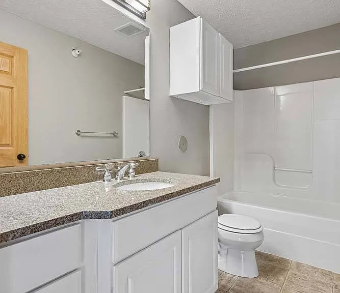 Refresh and recharge in this bright, modern bathroom featuring clean finishes and plenty of space for your daily routine.