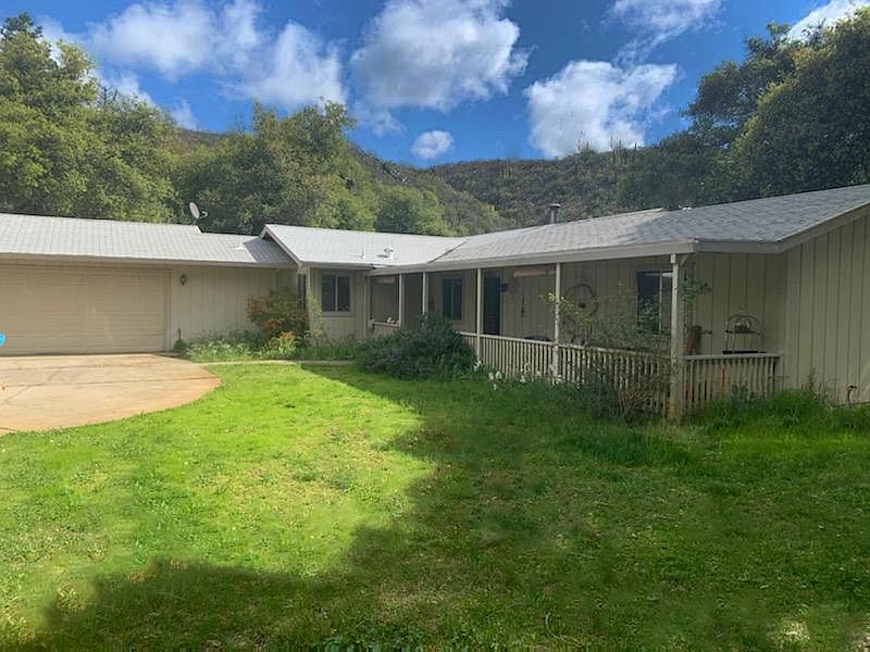 Front of house showing two car attached garage and laundry area. Front porch and the beautiful hillside above and across the canyon from the house. If you are interested please email a request for an application. I will require credit reports and proof of